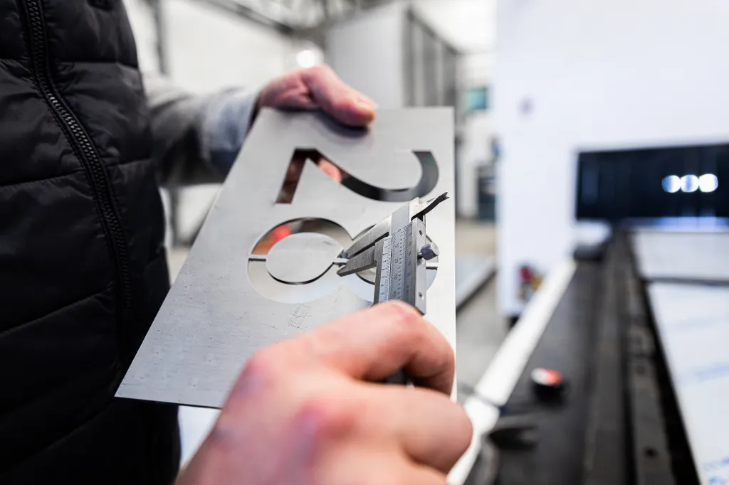 close-up-of-mans-hands-inspecting-laser-cut-of-met-2025-01-29-12-51-52-utc